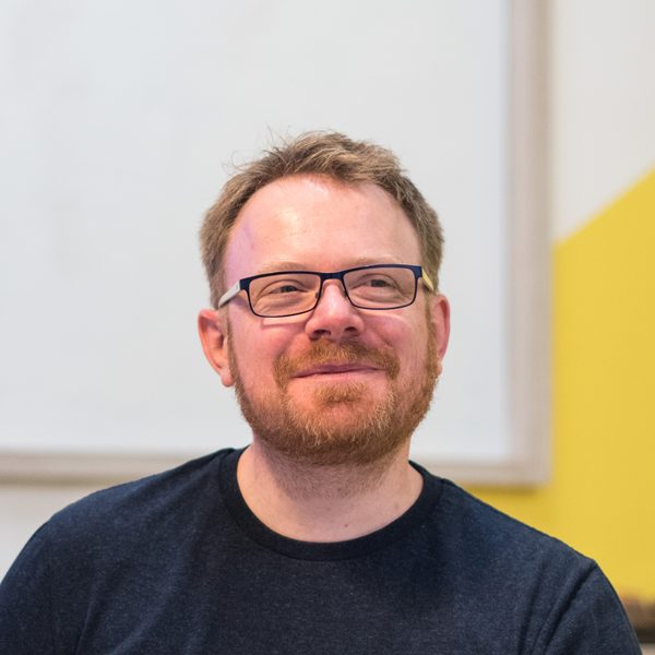 Matt Chick smiling, in the Chick office in Colchester