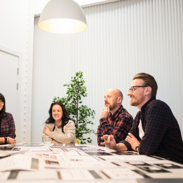 The Chick team around a table with a client