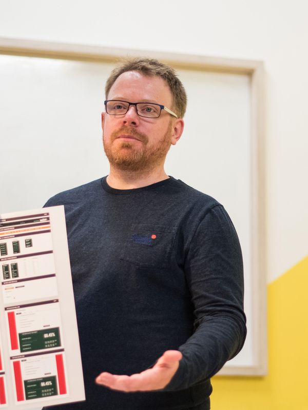 Matt holding a printed design during a workshop